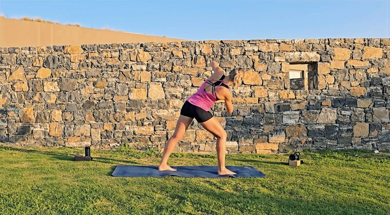Pilates Städtetrip, Rotation von der Kamera weg, Stand im Ausfallschritt, Mauer