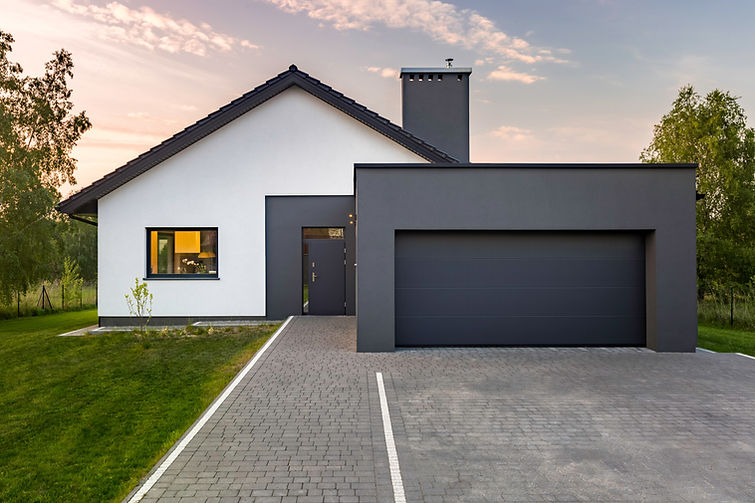 Modern house with garage and green lawn, exterior view.jpg