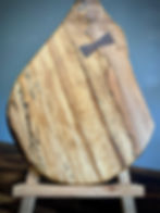 Thumbnail: Exquisite wooden cutting board with elegant handle, perfect for displaying gourmet cheeses and charcuterie.