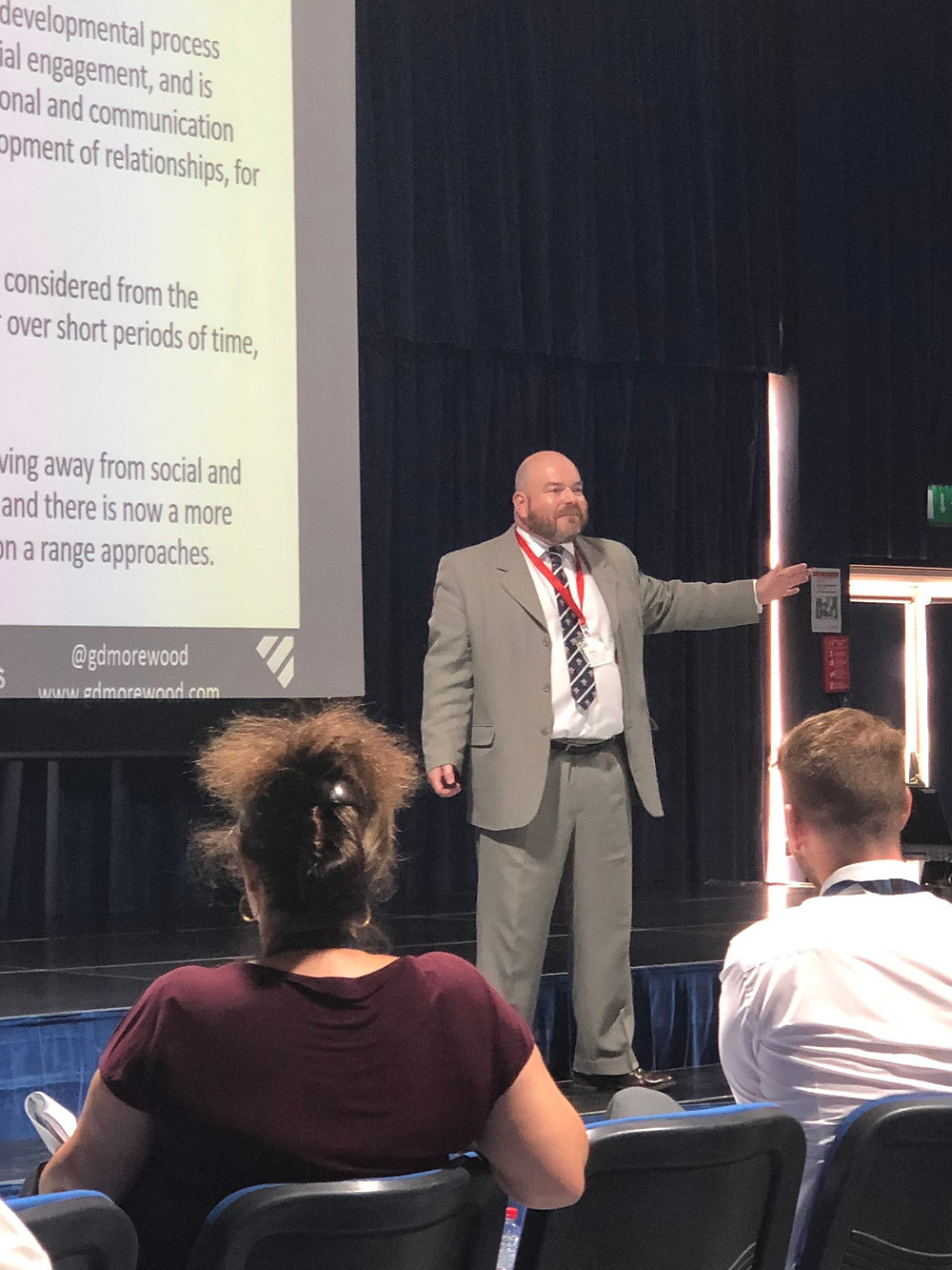 Gareth Morewood of Studio 3 on stage presenting training in low arousal, education and emotional regulation
