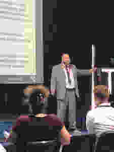 Gareth Morewood of Studio 3 on stage presenting training in low arousal, education and emotional regulation