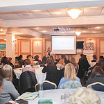 Image of delegates and presentation at #CoPro19