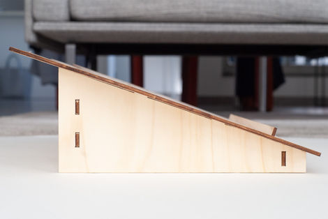 Side view of a laser cut plywood bookstand 