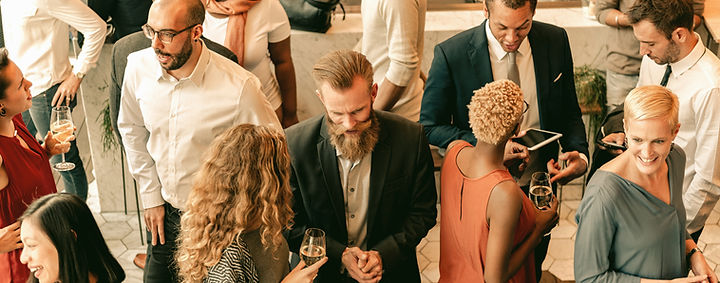 Diverse group of people at social event, mingling and chatting. Diverse crowd enjoy drinks
