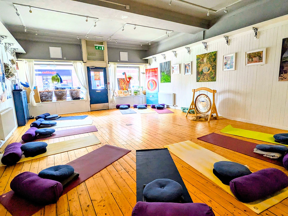 yoga studio set up with mats, bolsters and blankets.
