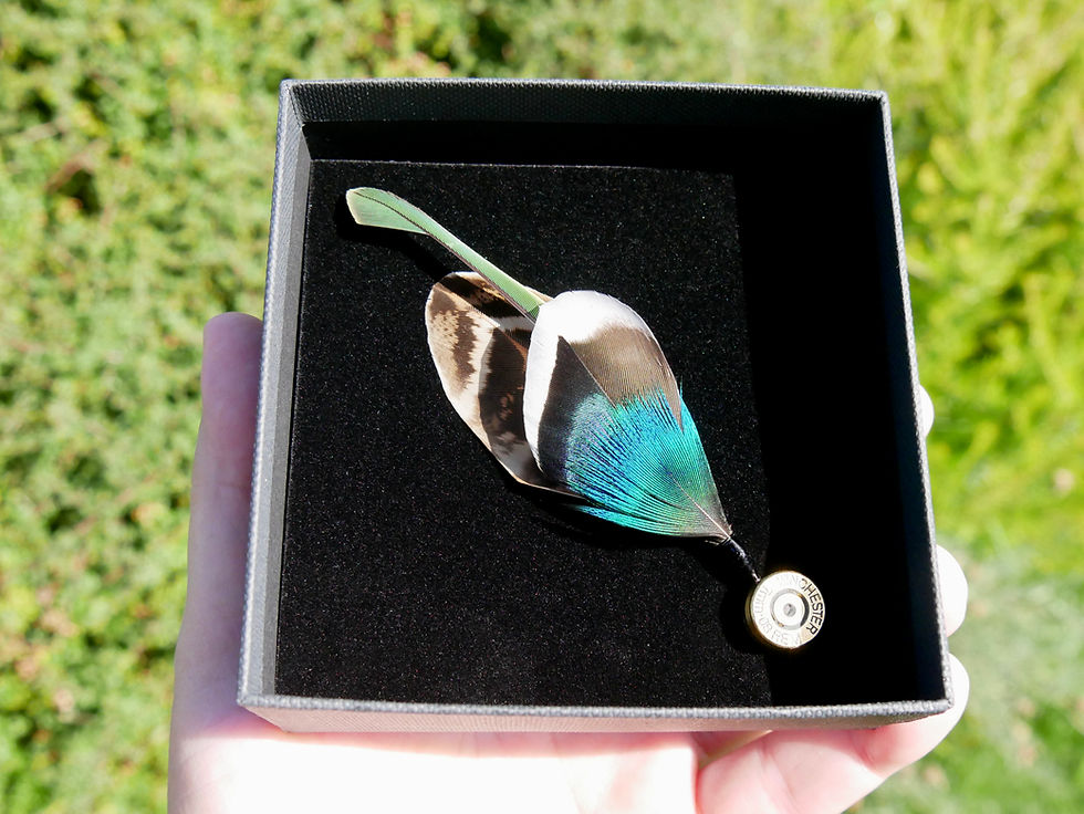 Bullet Casing Hat Pin With Feature Parrot Feather in presentation box.