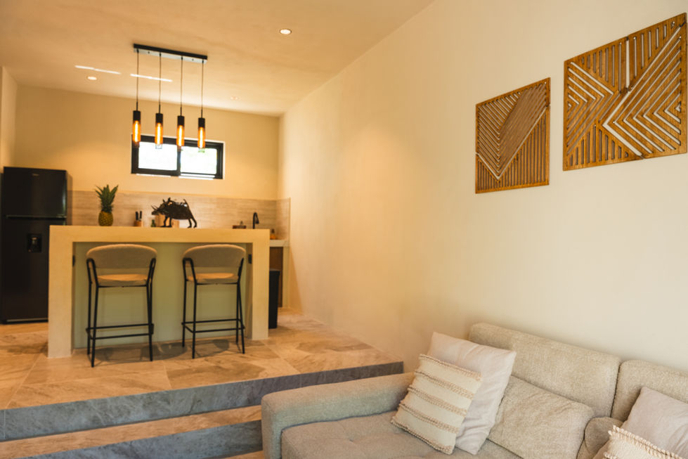 a living room with a couch and bar stools