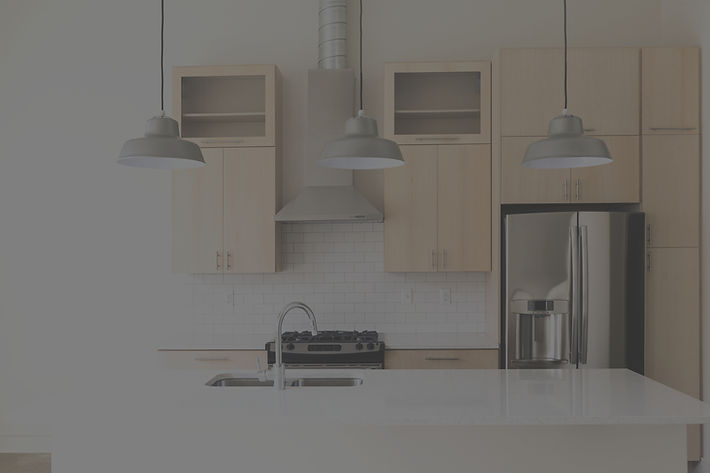 A kitchen featuring Caliber Cabinets, with a refrigerator, stove, and sink arranged for efficient cooking and meal prep.
