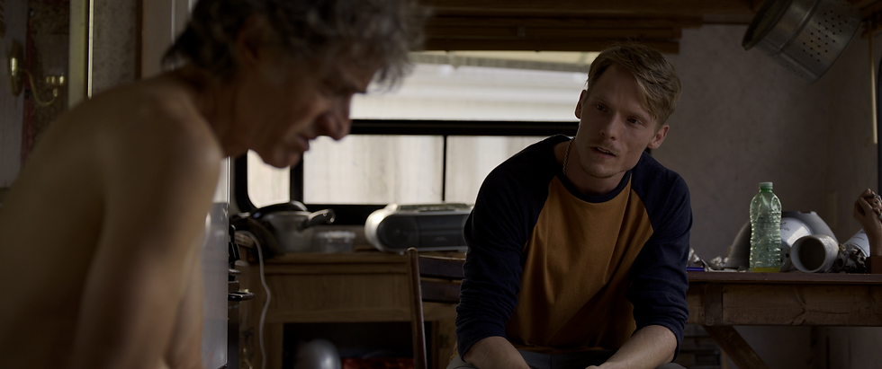 An image of actor Dakota Daulby as Joel and Emmanuel Bilodeau as Joel's father, Bodo, in the movie Tight Lettuce.