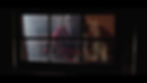 An image from the queer slasher movie Blowie. The image features a killer blow-up doll starring through the window at the character Black Bishop,