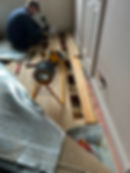 Floorboards lifted to install new electrical cables during a house rewire