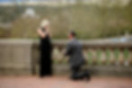 woman covers her face moments after her boyfriend proposes