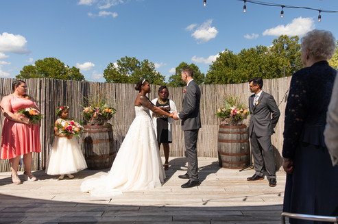 bride and groom holding hands during their wedding ceremony 