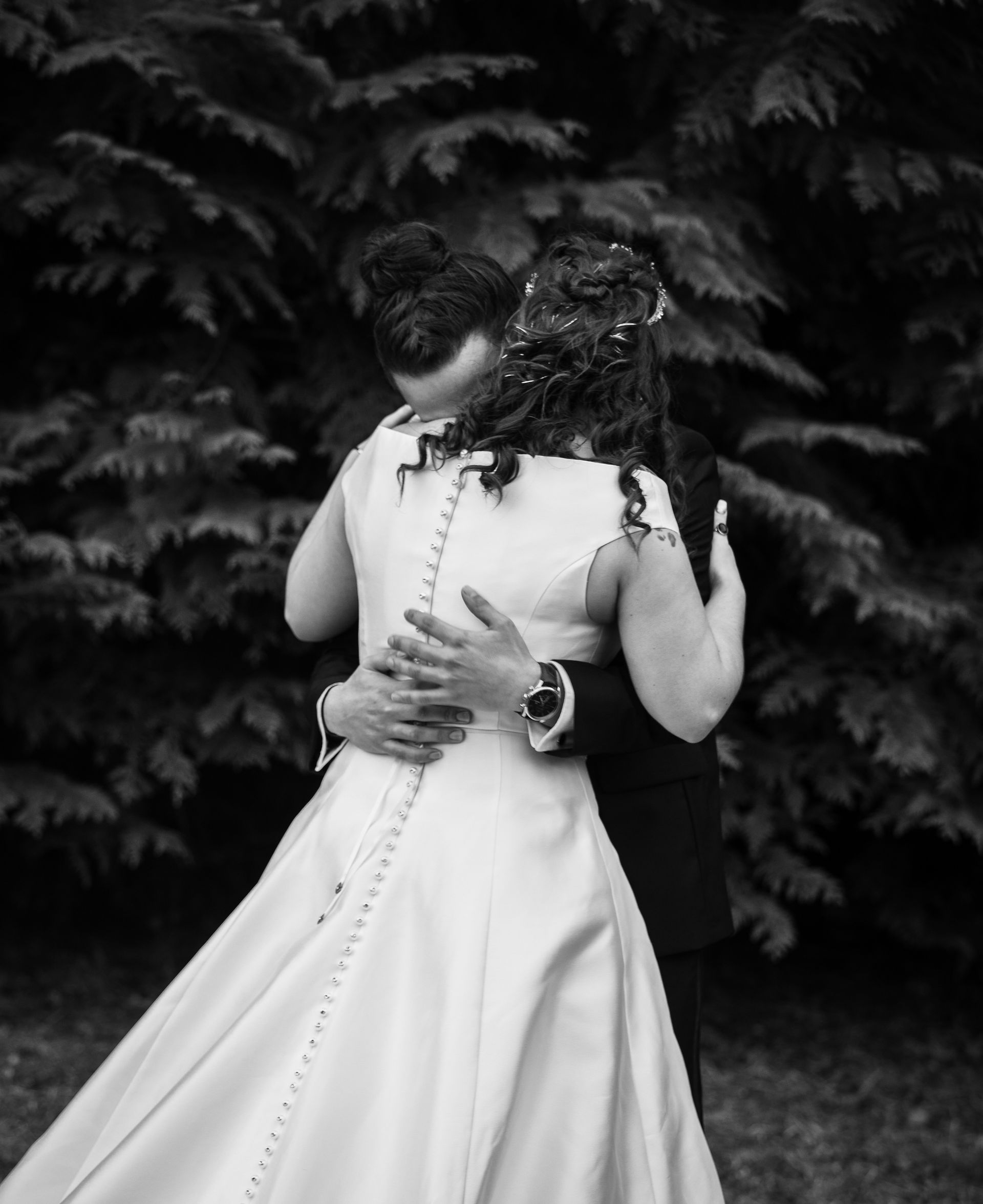 bride and groom hugging 