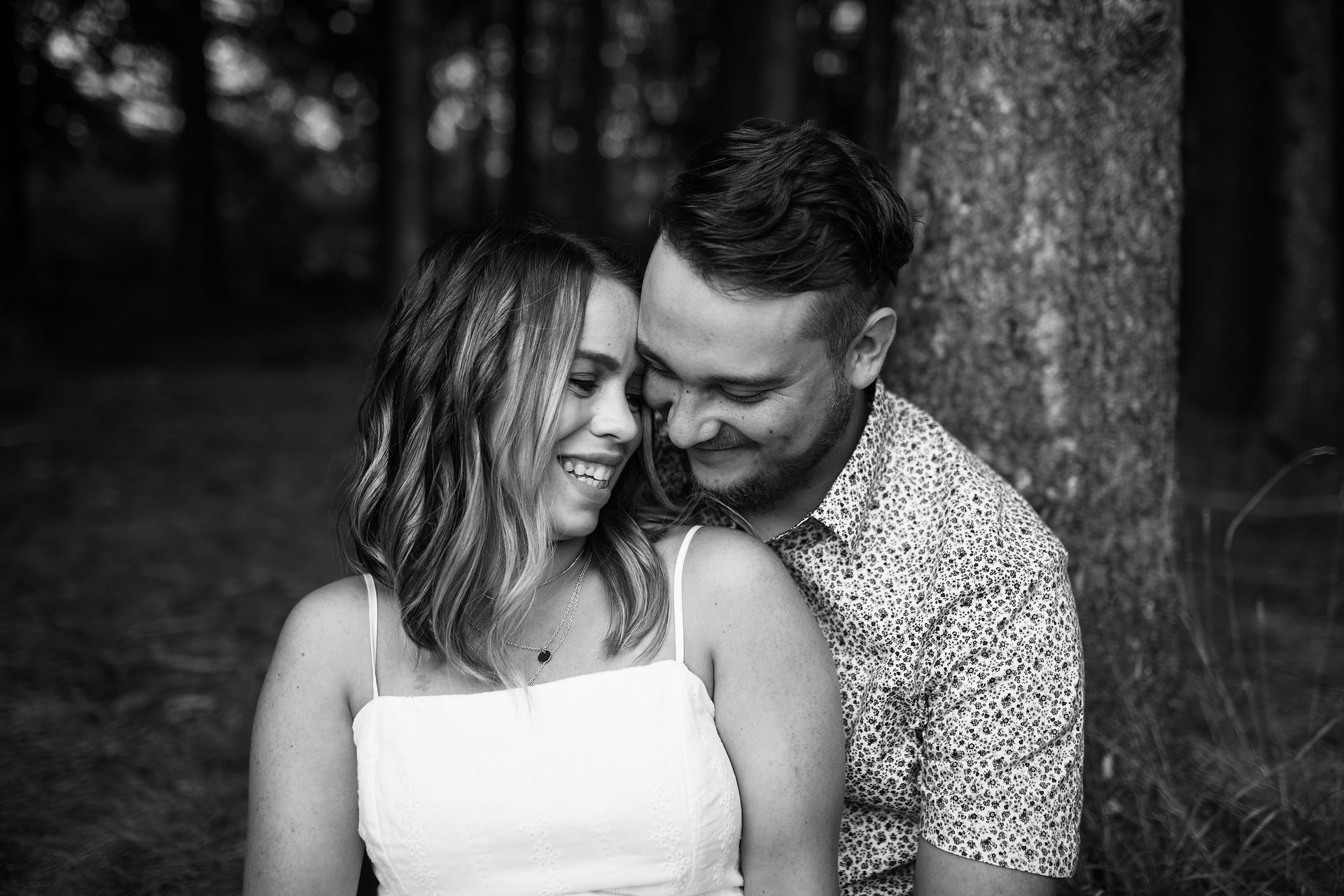 groom nestling up on bride from behind 