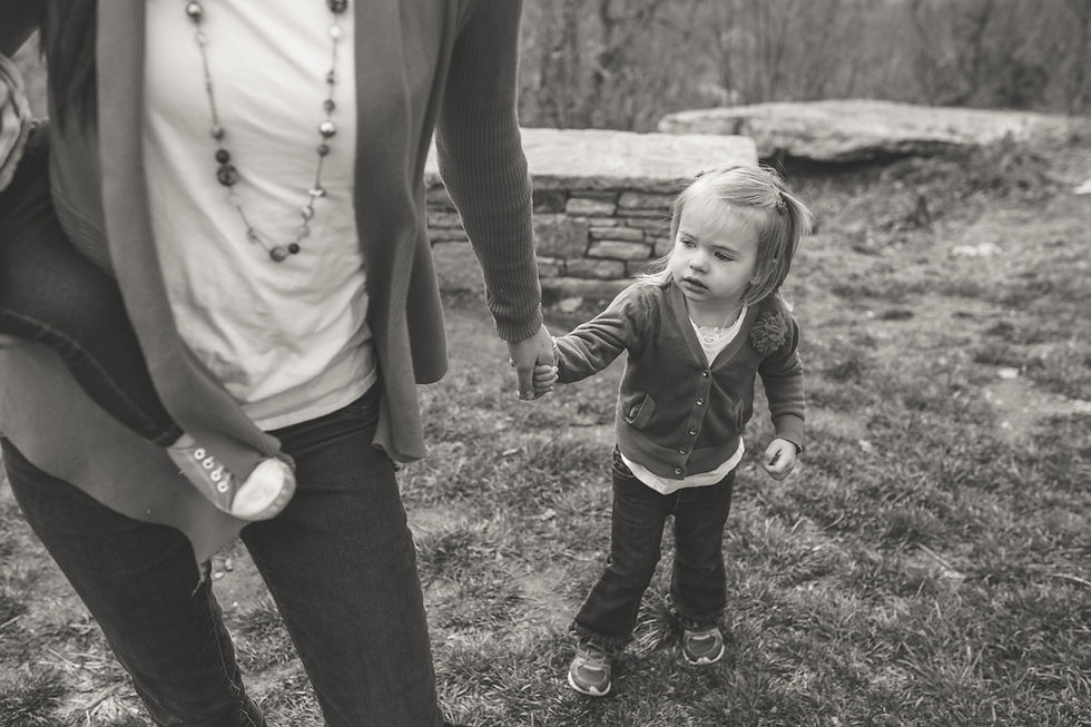 little girl holding her mom's hand
