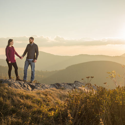 sunset portrait of a couple holding hands in the mountains