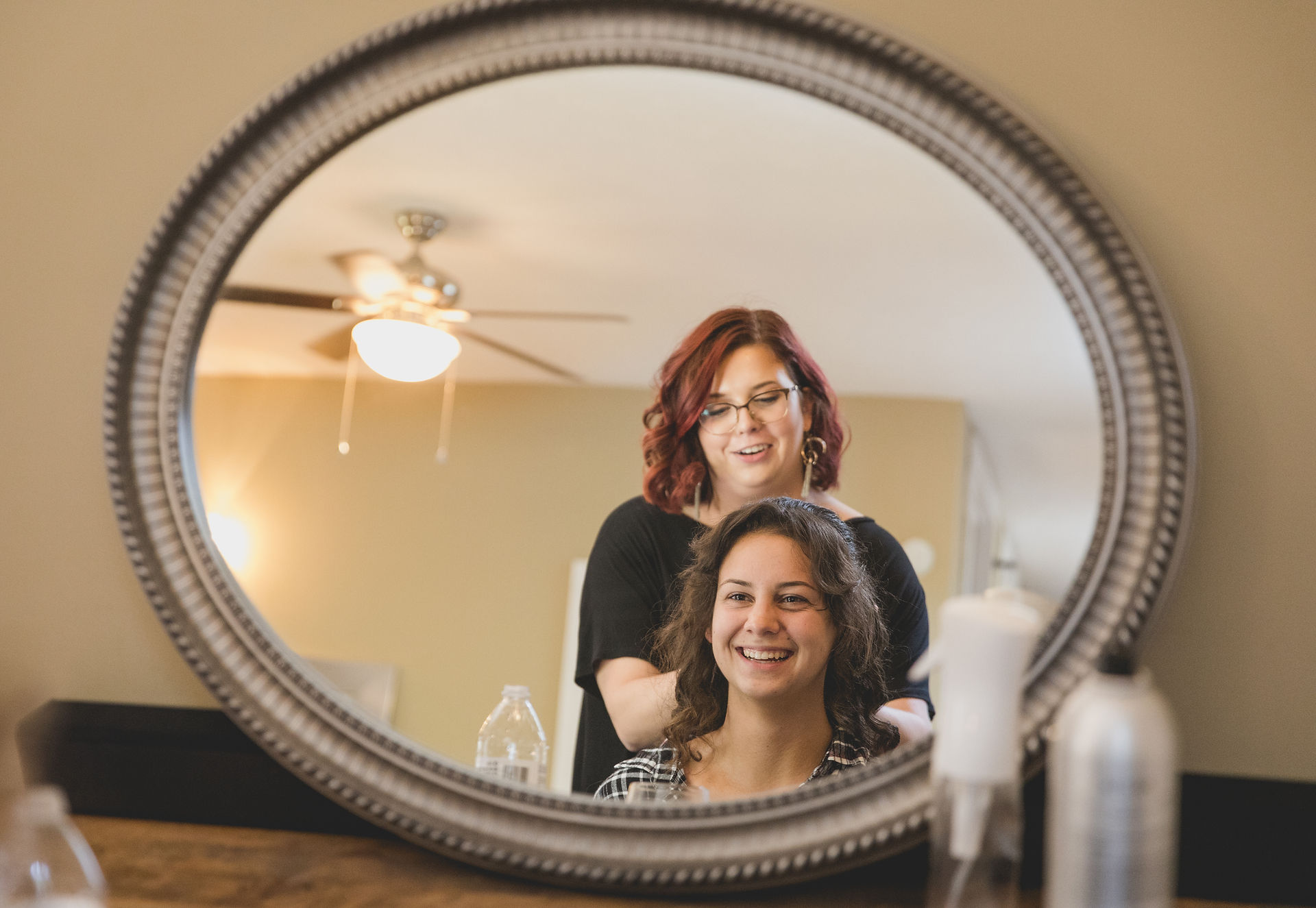 bride laughing in the mirror