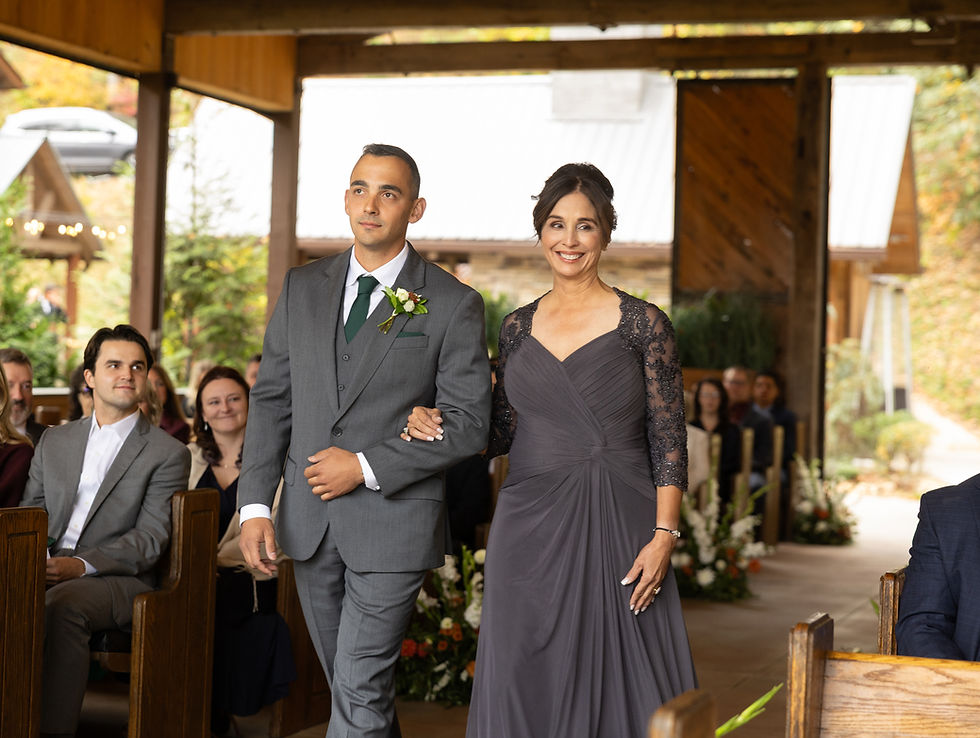 The groom and his mother walking down the aisle.