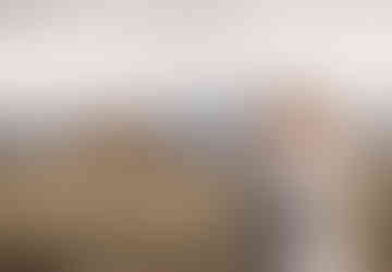 A bride and groom share a romantic embrace in front of the John Moulton Barn on Mormon Row near Jackson, Wyoming.