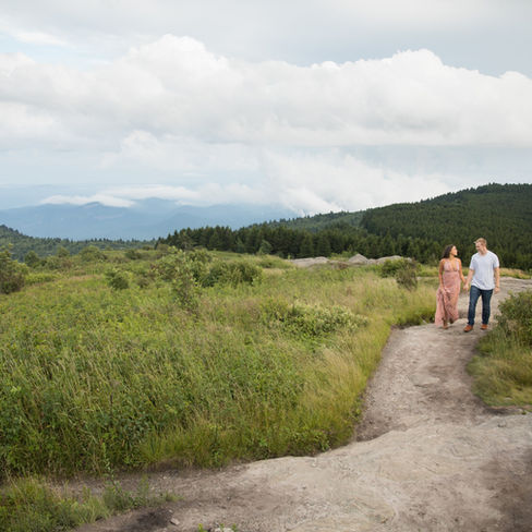 couple holding hands and walking at black balsam knob