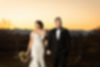 dramatic lighting sunset portrait of the bride and groom looking opposite directions