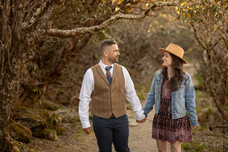 couple holding hands and smiling at each other 