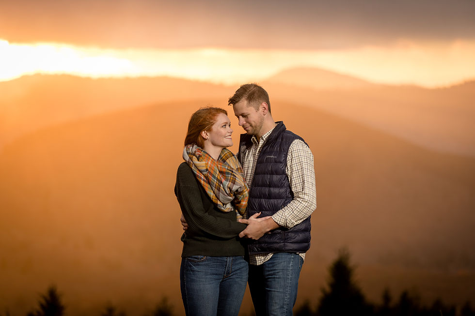 engaged couple holding each other in the golden hour sunset