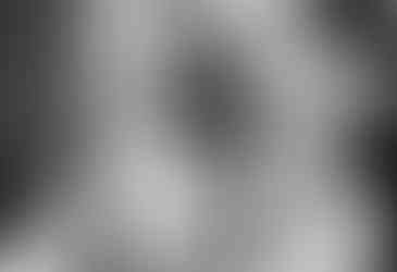 bride's mother helping her with buttons on her dress