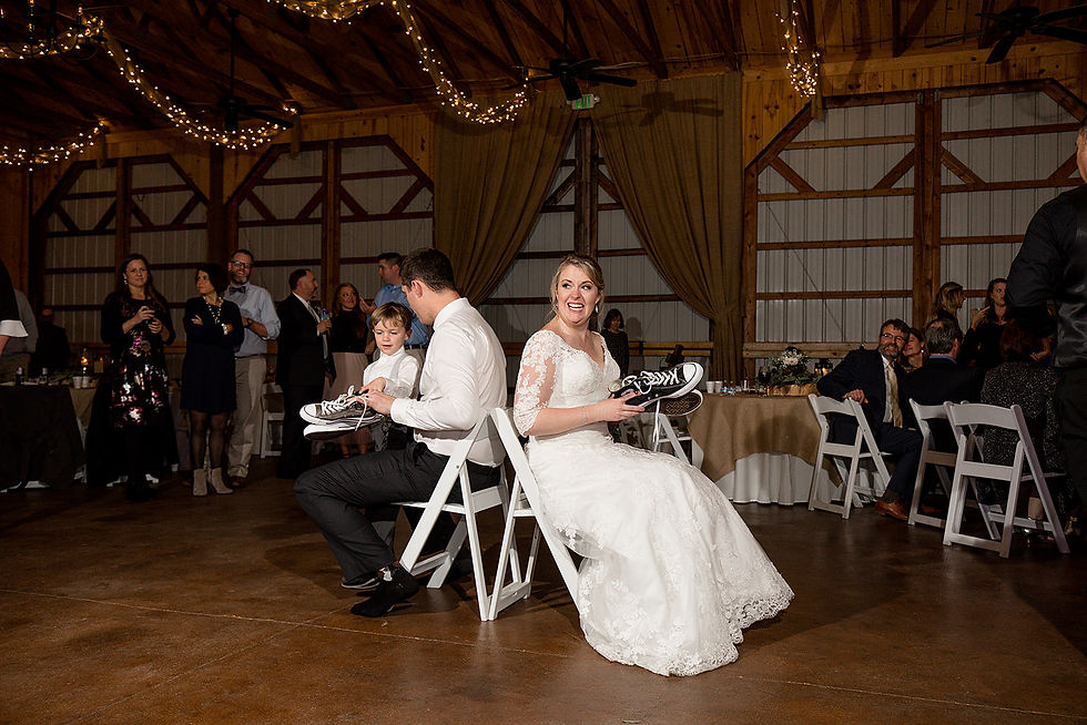 bride laughing while her and the groom play the shoe game