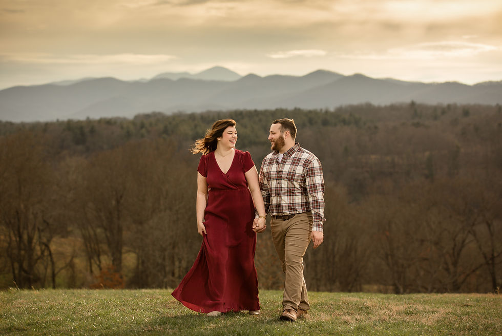 a couple holding hands and walking in front of the mountains