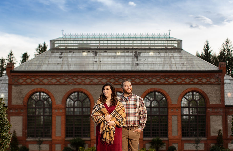 dramatic lighting portrait of a couple standing in front of the conservatory at the biltmore