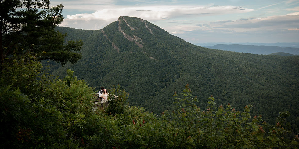bride and groom kissing as the groom holds her from behind