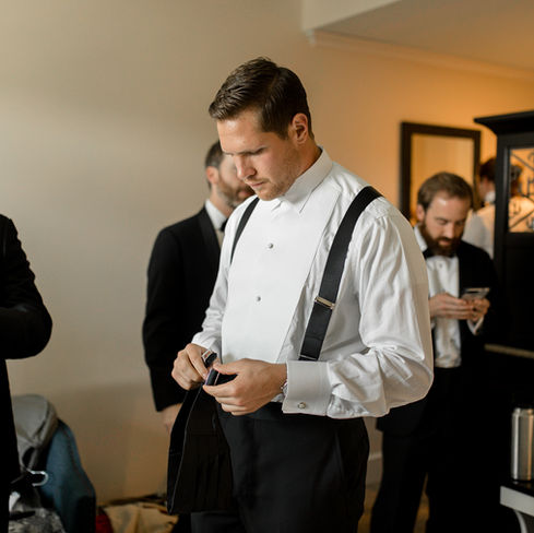 groom putting his watch on