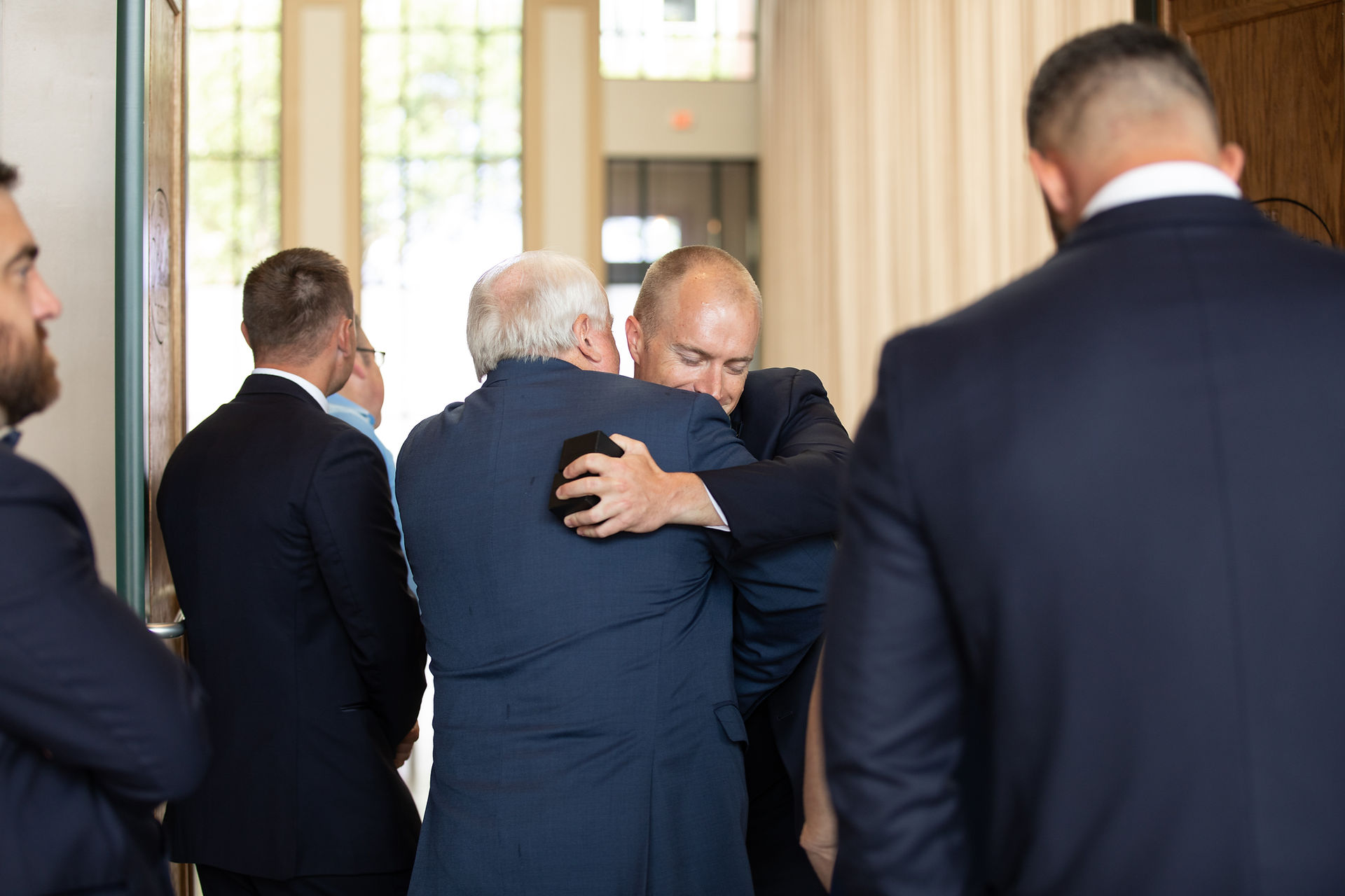 groom hugging his grandfather 