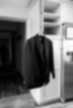 the groom's suit hanging int he kitchen