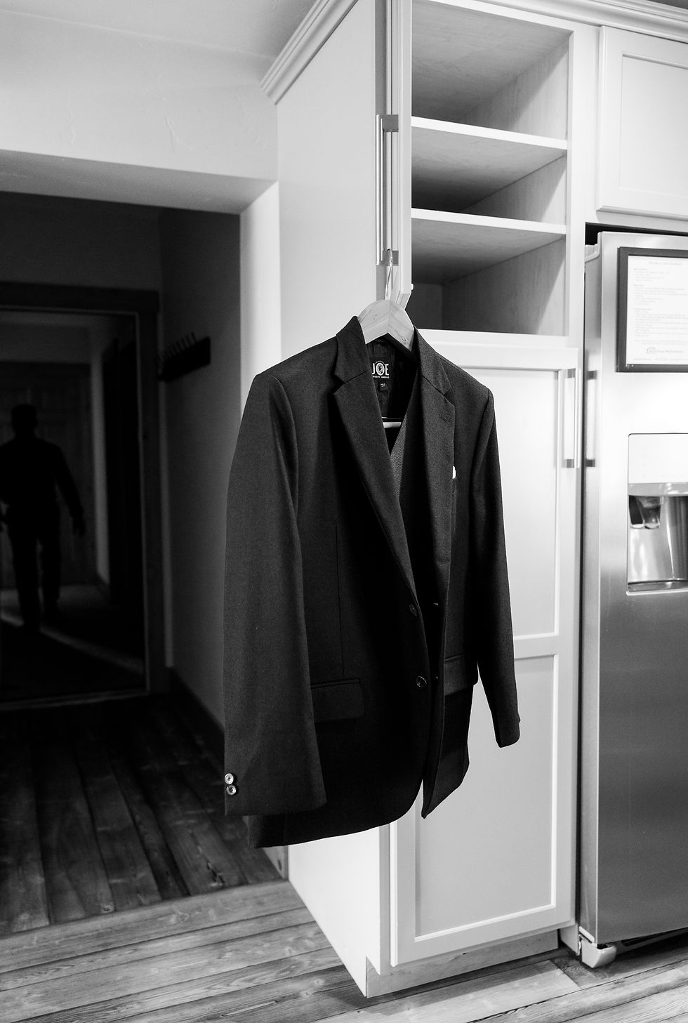the groom's suit hanging int he kitchen
