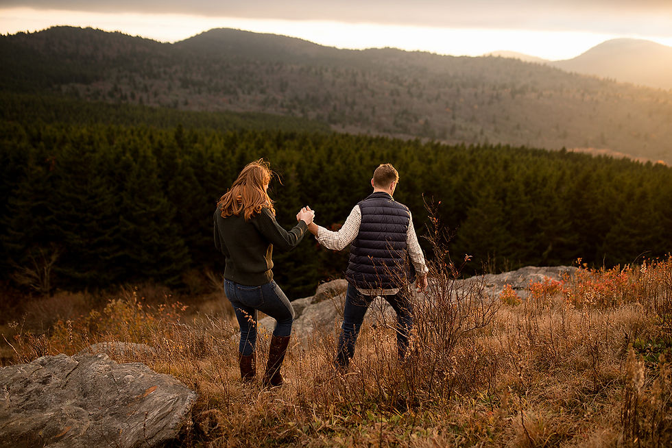 engaged couple holding hands and hiking at black balsam knob
