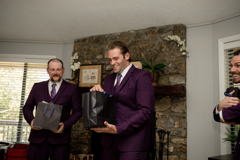 groomsman opening a gift