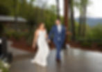 the bride and groom sharing their first dance in front of the mountains at the parker mill