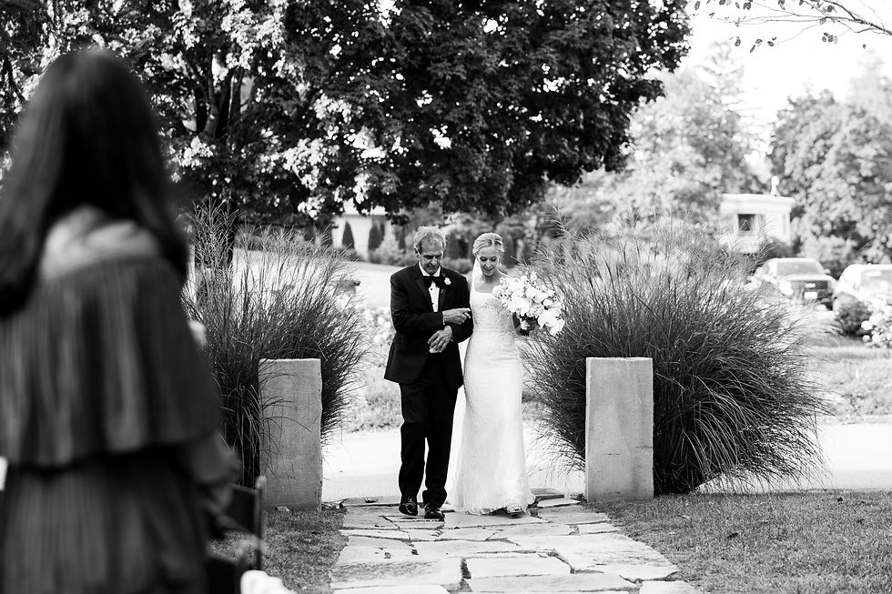 the bride and her father walking down the aisle