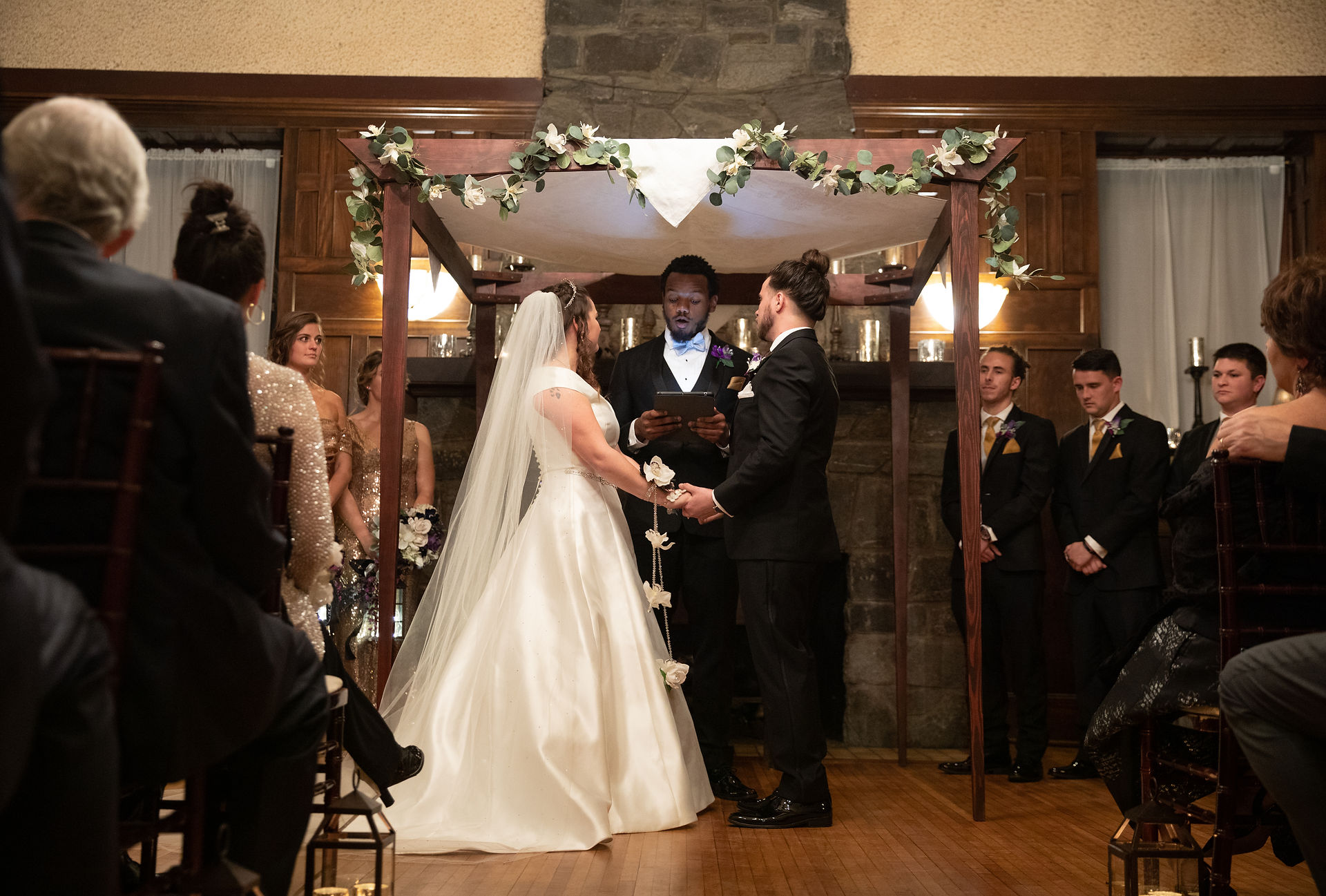 bride and groom holding hands during their ceremony 