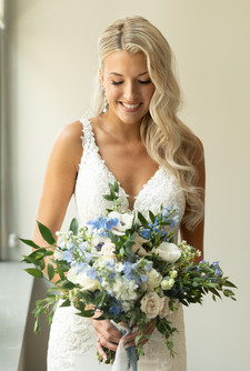 bridal portrait of bride looking down at bouquet
