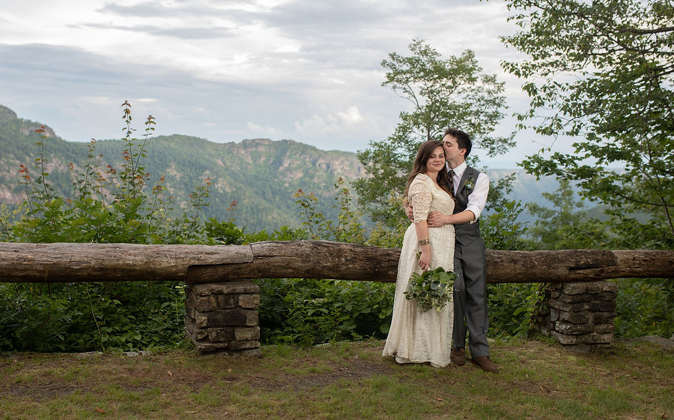 groom kissing the bride on the temple