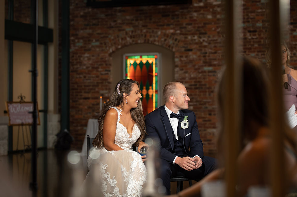 bride and groom laughing during speech