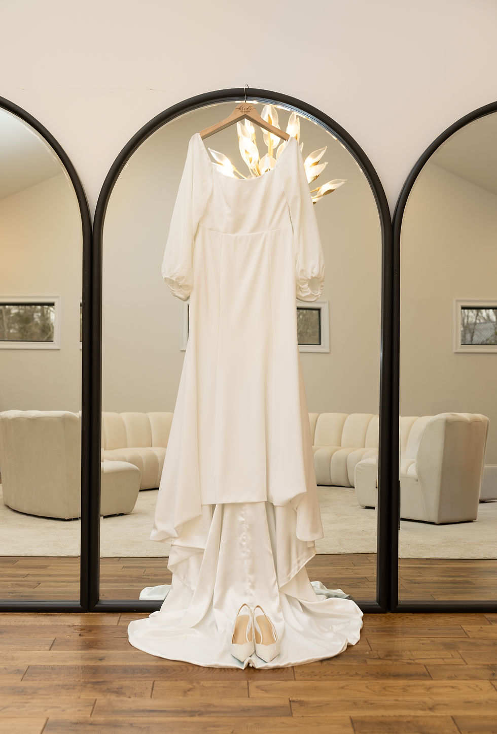 The wedding dress hanging on a mirror in the Nichols Heir Bridal suite.