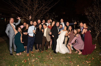 bride and groom taking a group photo with their friends 
