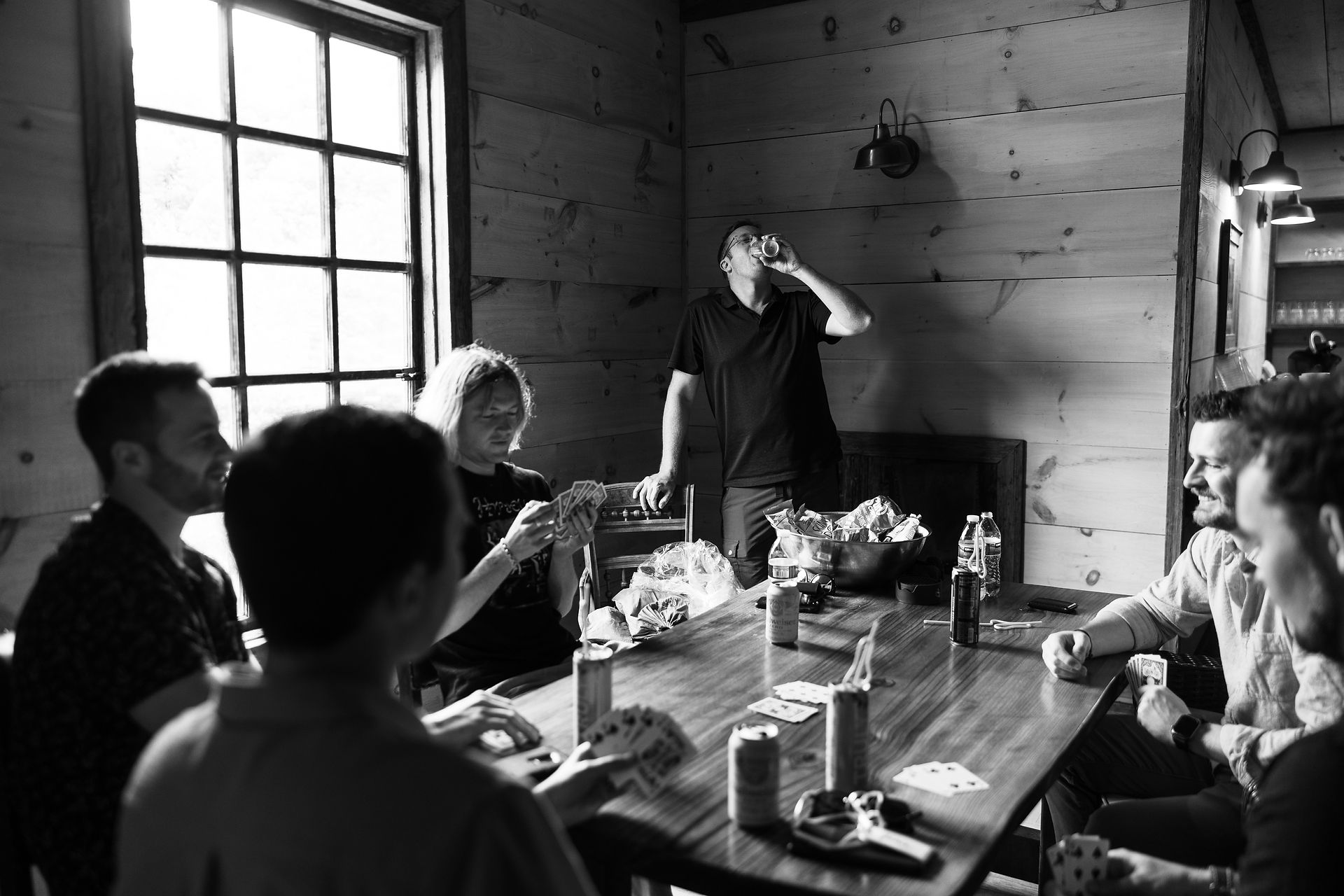 the groomsmen gathered round having drinks 