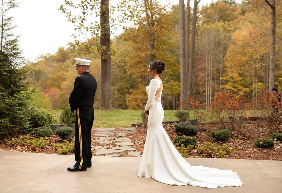 The bride approaching her dad from behind for the father daughter first look.
