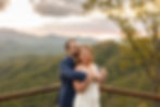 the groom holding the bride and kissing her head